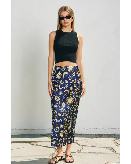 Woman wearing a black sleeveless top and a blue skirt with star and moon pattern.