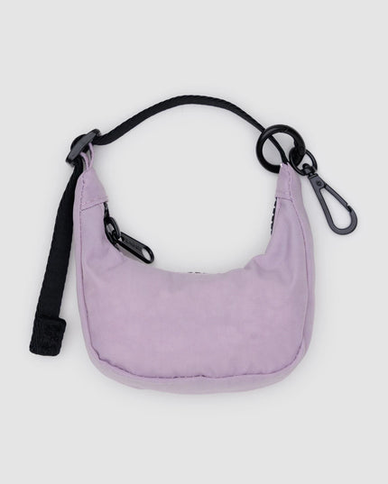 Purple shoulder bag with a black strap on a light gray background