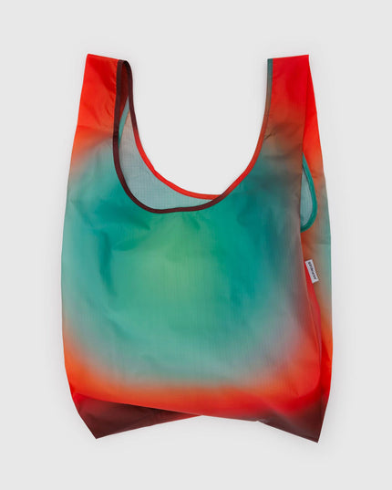 Gradient reusable bag with red to green color transition on a white background