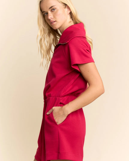 Woman wearing a red dress against a beige background