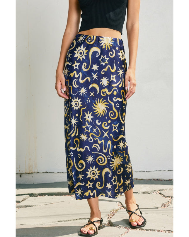 Person wearing a navy blue skirt with celestial pattern on a white background