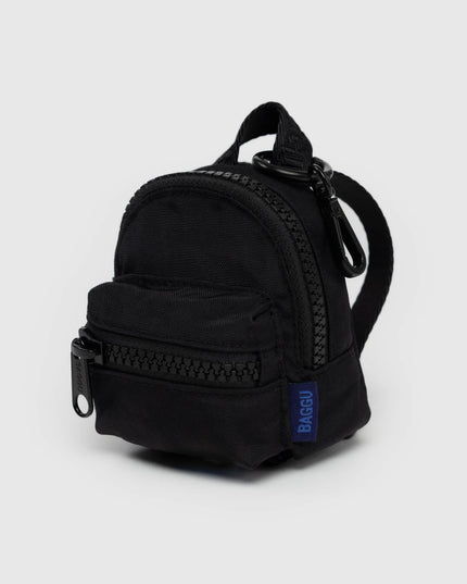 Black mini backpack with a visible brand logo on a light gray background
