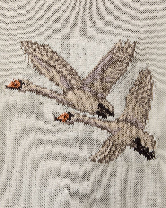 close up of swans on cream sweater 