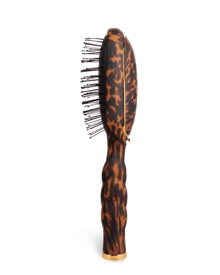 Hairbrush with tortoiseshell pattern on a white background