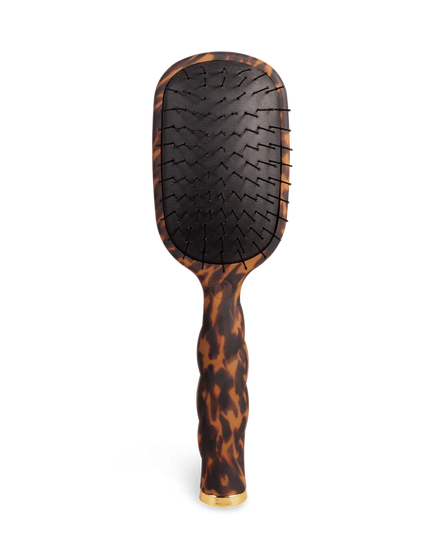 Hairbrush with tortoiseshell handle on a white background
