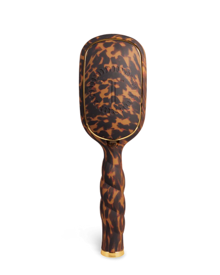 Tortoiseshell patterned hairbrush on a white background