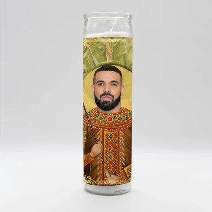 Candle with a printed design of a person in religious attire on a white background
