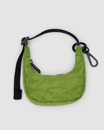 Green shoulder bag with a black strap on a white background