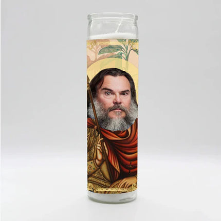 Candle with a printed design of a bearded figure in robes on a white background