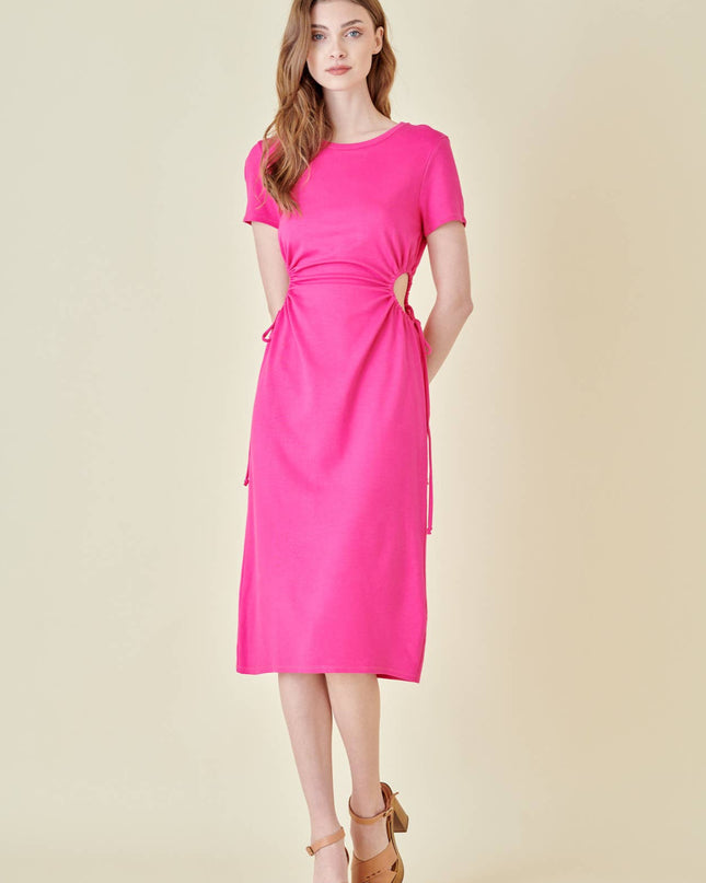 Woman wearing a bright pink dress on a beige background pink dress has cutout on side and tie