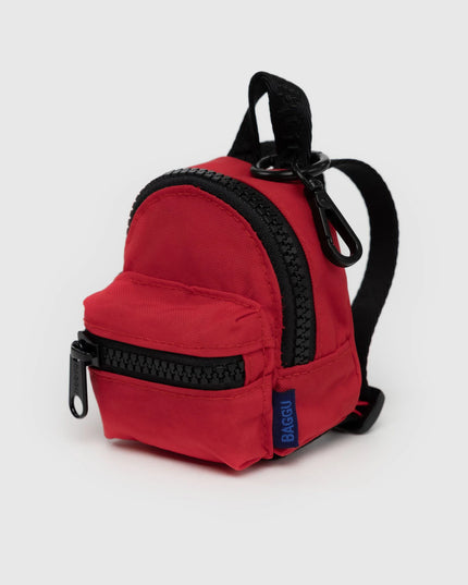 Red backpack with black zippers on a white background