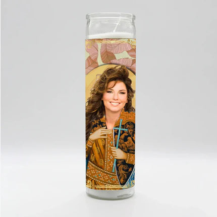 Candle with a printed design of a woman holding a cross on a white background