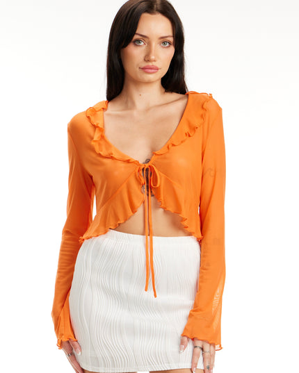 Model wearing Citrus Glow Ruffle Tie Front Top in bright orange with long sleeves and ruffle trim – Calli’s Curations boutique