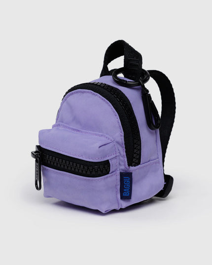 Small purple backpack with black straps on a light gray background