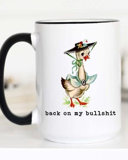 mug with black handle with  a good in a bonnet and the font says "back on my bullshit"