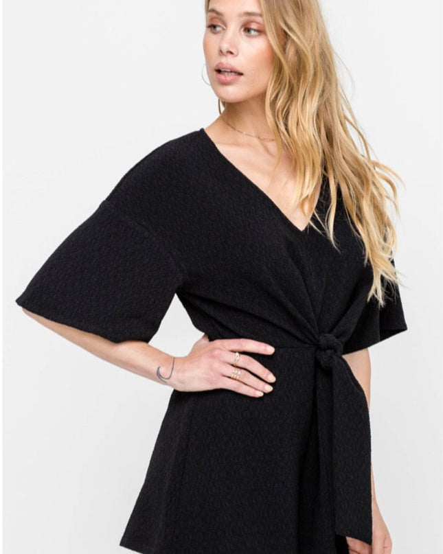 black romper with mid length sleeves and shorts and tie front