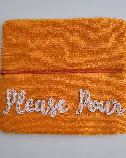 Open clutch with zipper section and white cursive script that says "please pour". Handbeaded all over.
