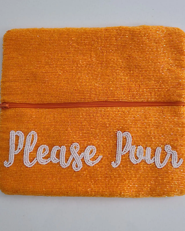Open clutch with zipper section and white cursive script that says "please pour". Handbeaded all over.